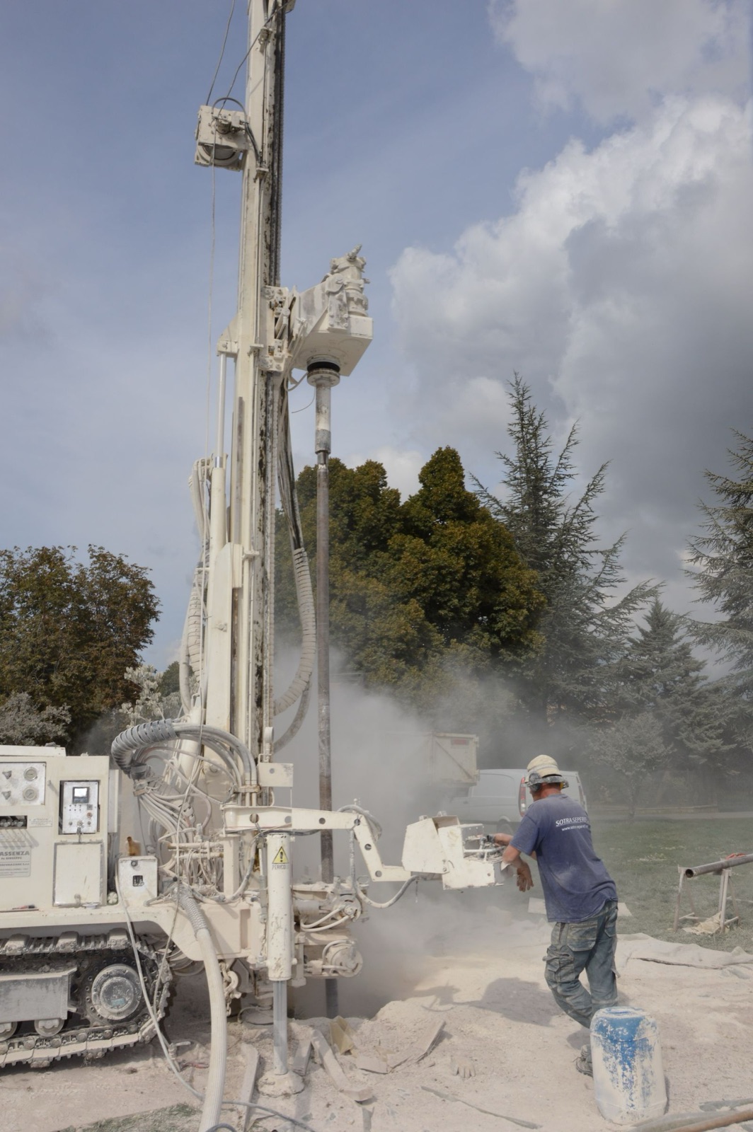 Operative working with a drilling rig to install fixings
