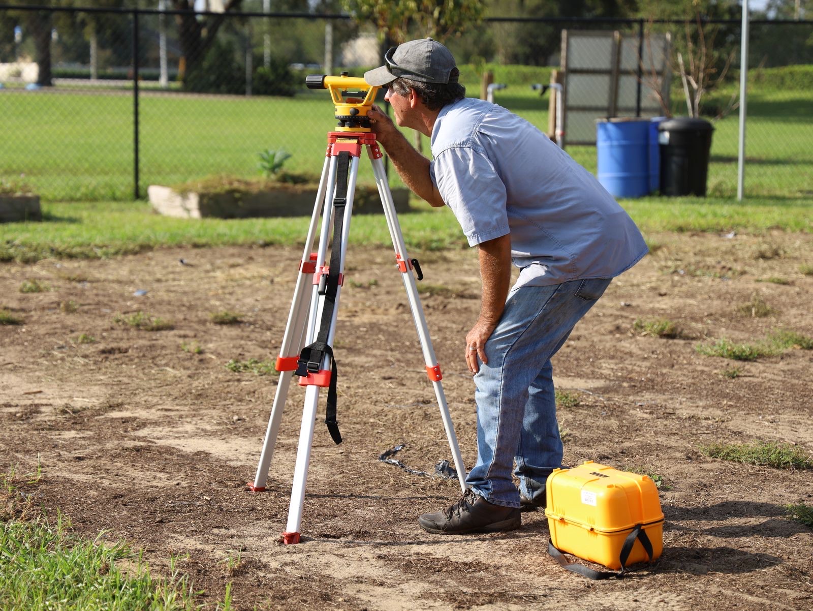 Surveyor carrying out a land survey with survey-grade instruments in London