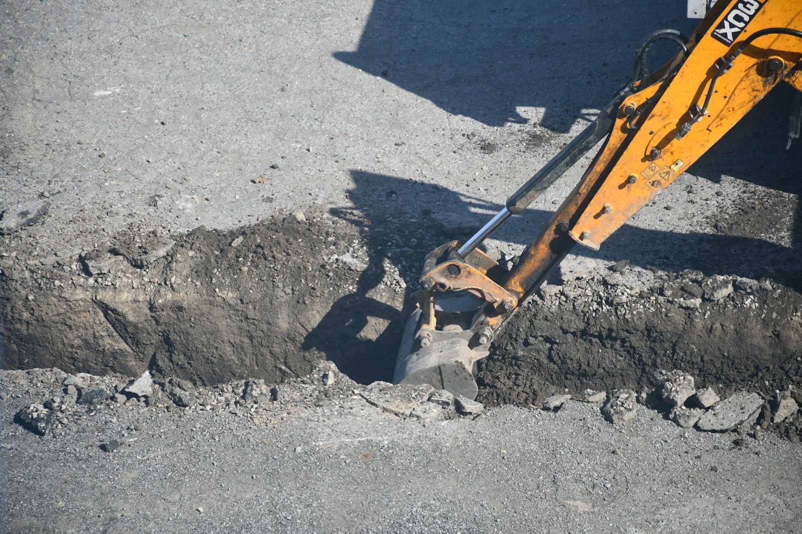 Excavated trench exposing buried services in a London road